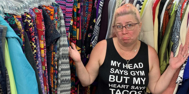 woman selecting used clothes wearing a clever shirt